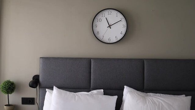 Clocks on white wall in bedroom