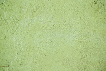 A green colored old wall texture background.