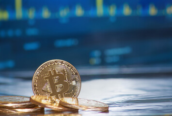 Gold bitcoin with growth graph chart trading view. Bitcoin gold coin and defocused chart...
