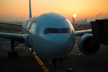 Fototapeta na wymiar Airplane turbine detail with sunrise background in the morning