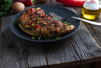 Mediterranean omelet on rustic and wooden table background