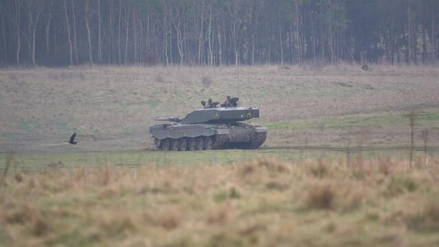 British army FV4034 Challenger 2 main battle tank covering rough ground quickly, in action on a military exercise, Salisbury Plain Wiltshire UK