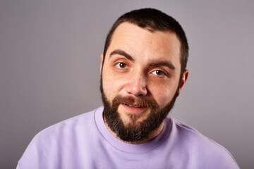 Fototapeta premium funny bearded man wears violet sweater on grey background