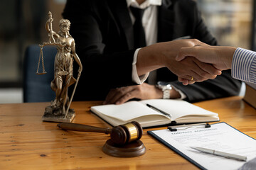 Lawyers shake hands with clients who come to testify in the case of embezzlement from business partners who jointly invest in the business. The concept of hiring a lawyer for legal proceedings.