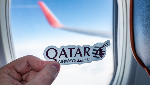 December 6, 2021, Doha, Qatar. The emblem of the airline Qatar Airways on the background of the window of the aircraft.