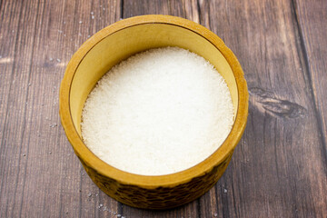 Seasoning salt. Salt is natural. Salt in a wooden box. Salt and hands.