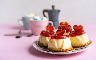 Bavarian cream pastry with strawberry jelly, two cups and caffe pot