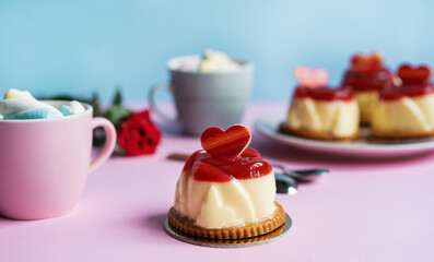 Bavarian cream pastry with strawberry jelly, two cups and rose