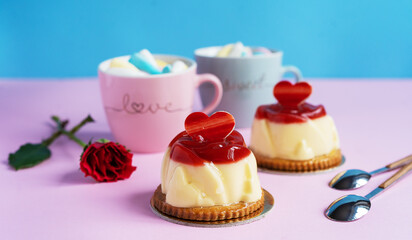 Bavarian cream pastry with strawberry jelly, two cups and rose
