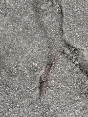 Old worn and cracked asphalt with deep cracks