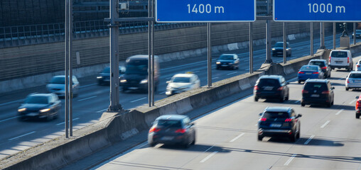 traffic on a German autobahn. View from a bridge to the highway with motion blurred vehicles.
