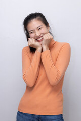 Happy Asian Woman Showing Shy Expression with Both Fist Touching Her Cheek