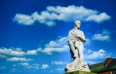 Robbie Burns statue on blue sky at Dumfries, Scotland. - obrazy, fototapety, plakaty