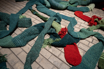 a tangle of colored crocheted rags made of natural materials