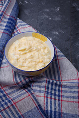 Radish, boiled eggs and sour cream salad in little bowl on grey wooden background. Healthy food, homemade meal, vertical close up, copy space.