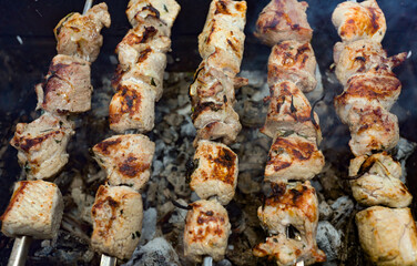 pork kebab on skewers is fried on coals. It looks appetizing and delicious, and the aroma excites the appetite