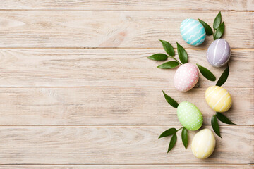 Colorful Easter eggs with spring flower leaf isolated over white background. Colored Egg Holiday border