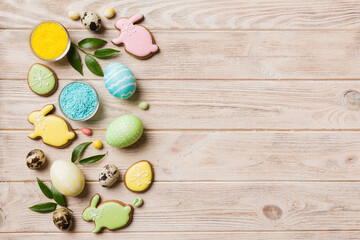 holiday preparation Multi colors Easter eggs with cookies on colored background . Pastel color Easter eggs. holiday concept with copy space