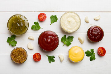 Many different sauces and herbs on table, flat lay top view. sauces with spices healthy concept