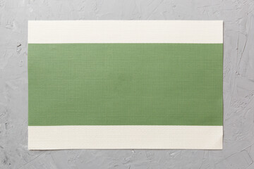 Top view of green tablecloth for food on cement background. Empty space for your design