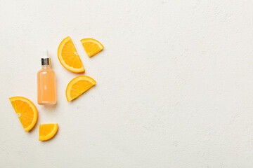 Bottles with orange fruit essential oil on wooden background. alternative medicine top view with copy space