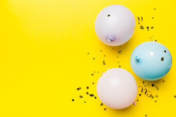 Background with fastive air balloons of round shape and confetti, multicoloured top view. Birthday party background