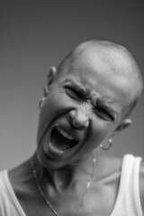 emotional studio portrait of a young attractive bald girl black and white image