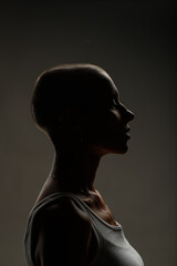 emotional studio portrait of a young attractive bald girl