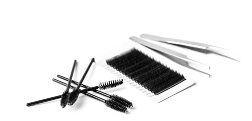 Set black lashes and brush tweezers in white isolated background, eyelash extension concept