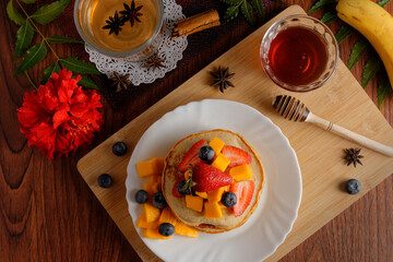 Hotcakes served ready for breakfast. Hotcakes decorated with strawberries.