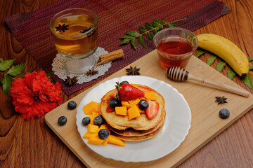 Hotcakes served ready for breakfast. Hotcakes decorated with strawberries.