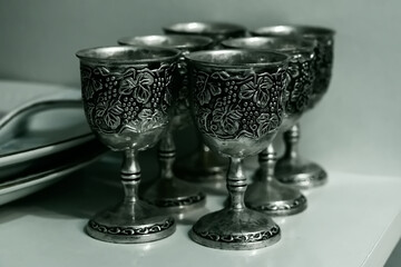 Antique vintage wine glasses made of embossed silver.