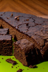 Sweet chocolate cake isolated on green background. Tasty creamy cake.