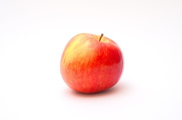 Red apple on a white background with a shadow.