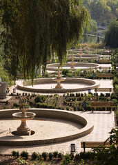 Landscape, resting place in the park, among fountains, shops and bridges