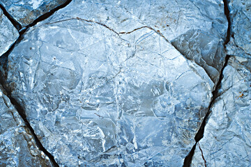 Rough structure mineral. Splits in ice. Cool background. Ice cracks. Rock texture. Ice texture. Stone background. Ice surface texture. Abstract texture. Lava frozen. Rock pile.