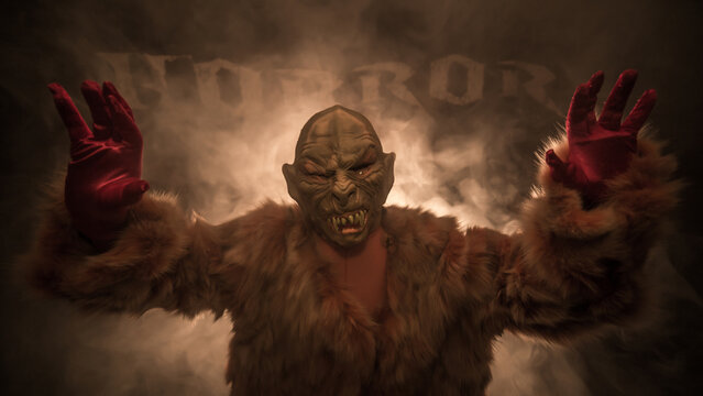 a vampire dressed in fur stands in the smoke and wants your blood