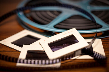Shallow focus background image of 35mm slides and 8mm Super 8 film reel with vintage filter - 491495326