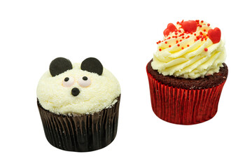 Two chocolate cupcakes with panda face cream shape and heart decoration on white background with copyspace