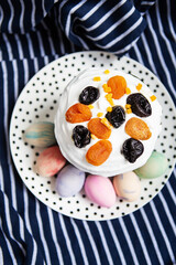 Easter eggs and Easter cake lie on a plate lying on a striped blue apron. Easter religious holiday concept.