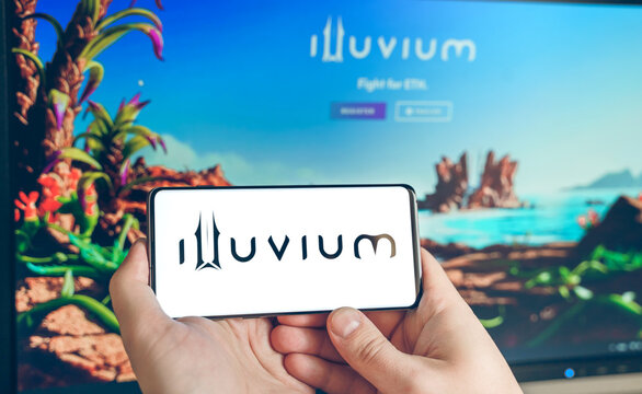 Russia Moscow 25.12.2021 Logo of Illuvium. ILV token, blockchain nft ethereum cryptocurrency strategy game in laptop,mobile phone.Man playing for crypto coins. Earning digital money. Play-to-earn
