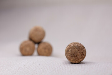 four wine corks with a pyramid on a light background.