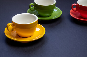 Beautiful color cups on a dark background