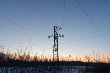 The support of a high-voltage power line with wires stretching to it from different sides.