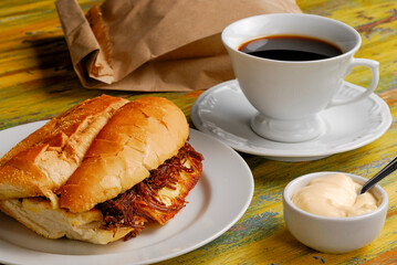 Sandwich. Roasted coalho cheese with shredded sun dried meat. Typical of northeastern Brazilian cuisine. Accompanied with a cup of coffee.
