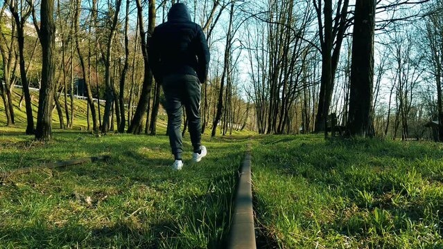  A Man Walks Along an Abandoned Railway