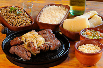 sun-dried meat with beans, rice, farofa, cassava and vinaigrette. Carne de sol. Typical dish from the Brazilian northeast.