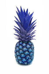 Pineapple painted blue on a white background. Crested pineapple in a vertical photo on a white background. Unusual coloring of pineapple in blue