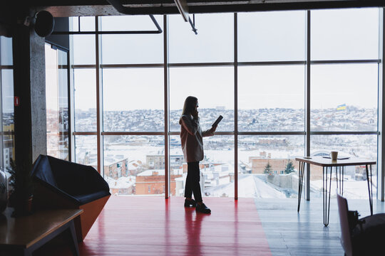 Successful Business Woman Standing Looking Out The Window Enjoying The City View, Confident Wealthy Leader Woman Thinking About Business Success And Vision For The Future, Planning New Goals