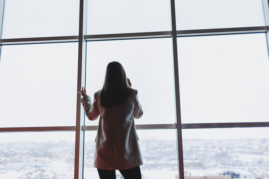 Successful Business Woman Standing Looking Out The Window Enjoying The City View, Confident Wealthy Leader Woman Thinking About Business Success And Vision For The Future, Planning New Goals